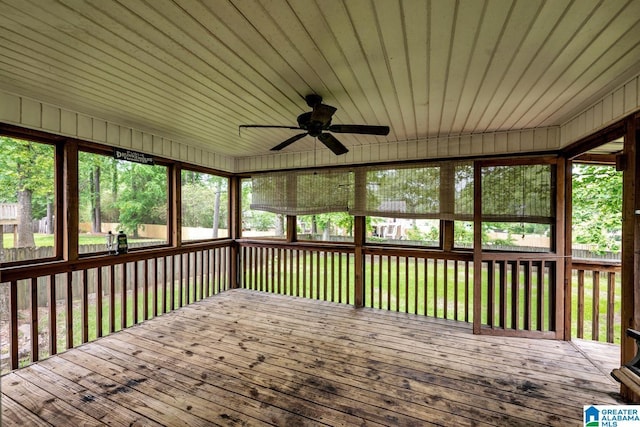 unfurnished sunroom featuring ceiling fan