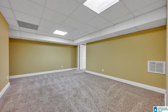 unfurnished room featuring carpet floors, baseboards, a paneled ceiling, and visible vents