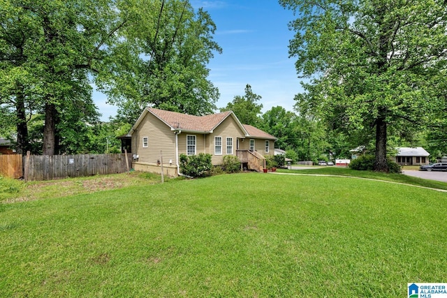 view of front facade with fence and a front yard