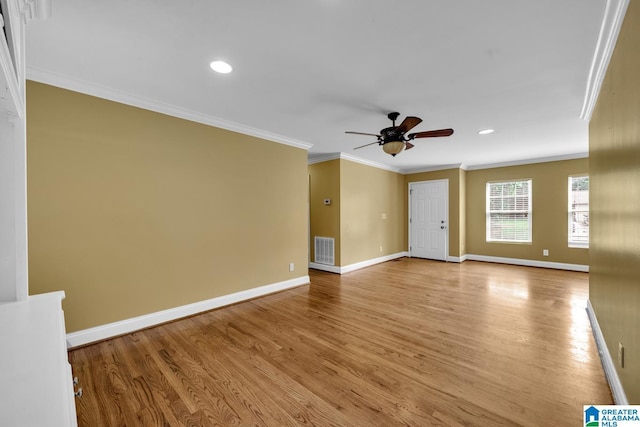 empty room with baseboards, ceiling fan, light wood finished floors, and visible vents