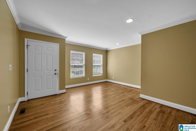 interior space featuring visible vents, ornamental molding, and baseboards