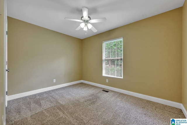 spare room with baseboards, carpet, and a ceiling fan