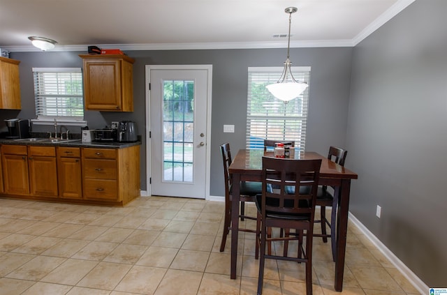 interior space with baseboards, ornamental molding, light tile patterned floors, and visible vents