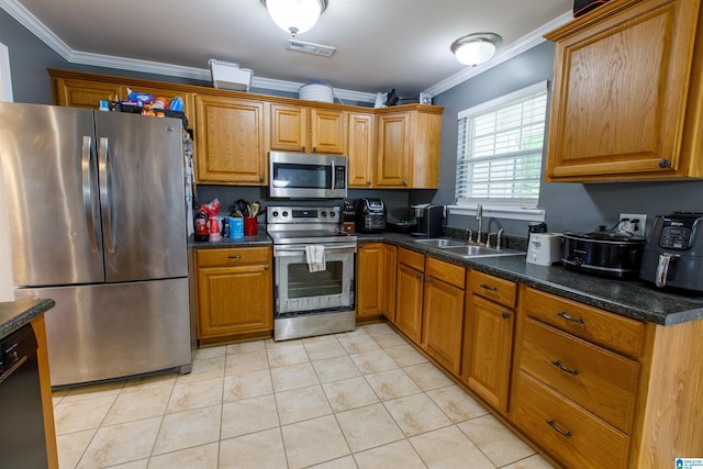 kitchen with crown molding, brown cabinets, appliances with stainless steel finishes, and a sink