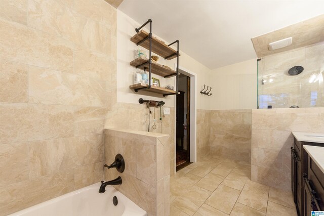 1836 Canton Rd, Vestavia Hills, AL 35216 - bathroom with tile walls, vanity, lofted ceiling, and tile patterned floors