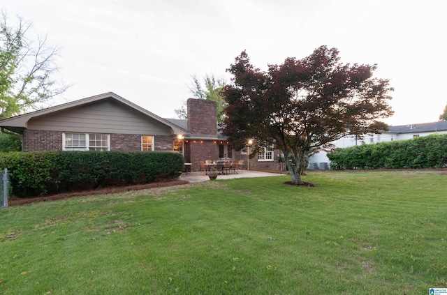 1836 Canton Rd, Vestavia Hills, AL 35216 - single story home with a patio, brick siding, a chimney, and a front lawn
