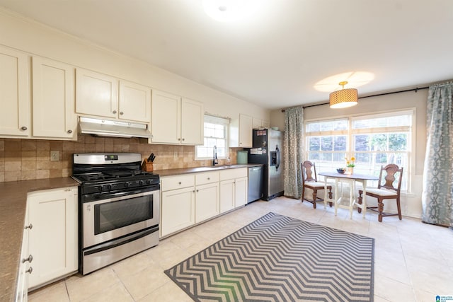 1836 Canton Rd, Vestavia Hills, AL 35216 - kitchen with stainless steel appliances, under cabinet range hood, a sink, decorative backsplash, and light tile patterned flooring