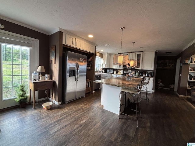 1525 Marvin Adcock Rd, Hayden, AL 35079 - kitchen with stainless steel fridge with ice dispenser, dark wood-type flooring, a textured ceiling, a breakfast bar, and a kitchen island
