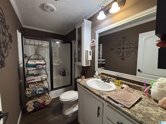 1525 Marvin Adcock Rd, Hayden, AL 35079 - full bathroom with wood finished floors, toilet, vanity, a textured ceiling, and bath / shower combo with glass door