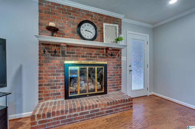 unfurnished living room with baseboards, ornamental molding, a brick fireplace, and wood finished floors