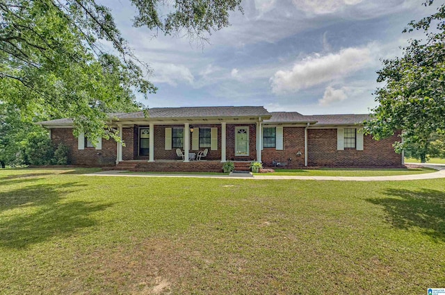 ranch-style house with a porch, brick siding, and a front yard