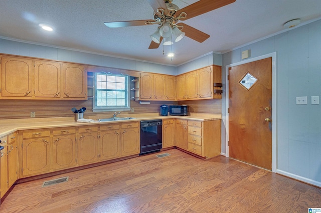 kitchen featuring crown molding, visible vents, a sink, and black appliances