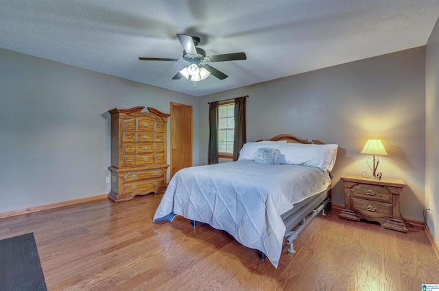 bedroom featuring baseboards, a ceiling fan, and wood finished floors