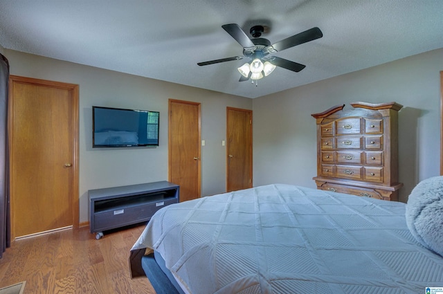bedroom with ceiling fan and wood finished floors