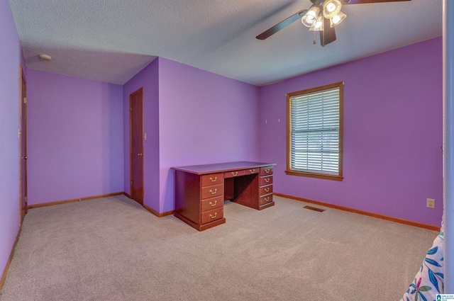 unfurnished bedroom with baseboards, light carpet, a ceiling fan, and visible vents