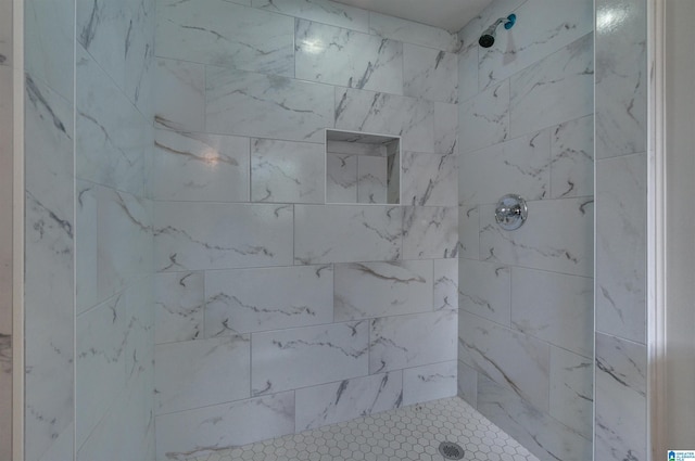 full bath featuring tiled shower