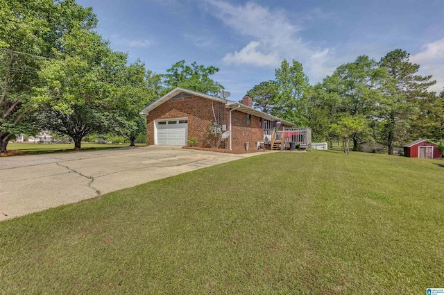 single story home with a front yard, a chimney, brick siding, concrete driveway, and an attached garage