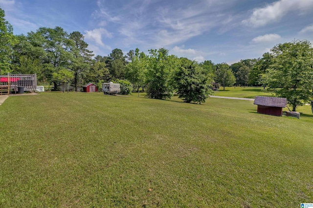 view of yard with an outbuilding and a storage shed