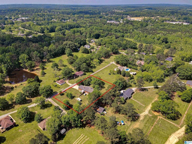drone / aerial view featuring a wooded view