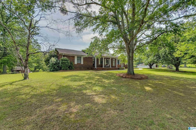 view of front of property with brick siding and a front yard