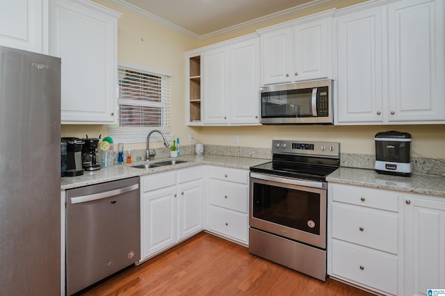 kitchen featuring white cabinets, stainless steel appliances, and a sink