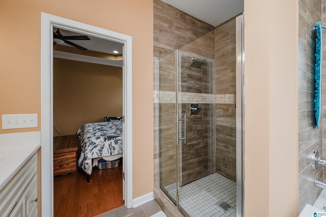 full bath featuring a ceiling fan, tile patterned floors, ensuite bath, and a stall shower