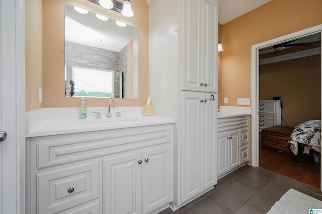 ensuite bathroom featuring vanity, tile patterned flooring, and ensuite bath