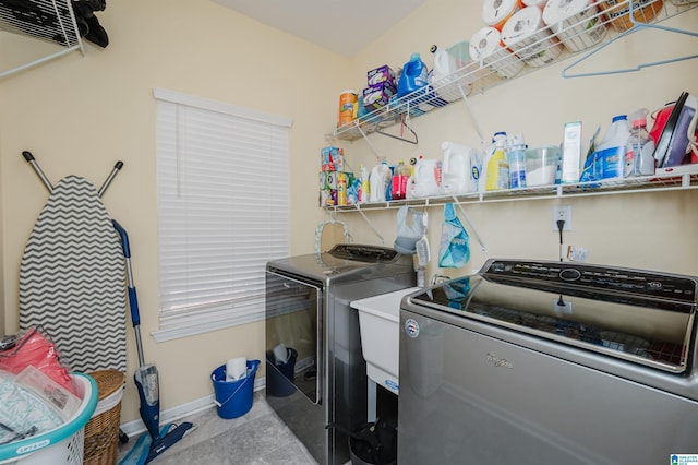 laundry area featuring washer and dryer, laundry area, and baseboards