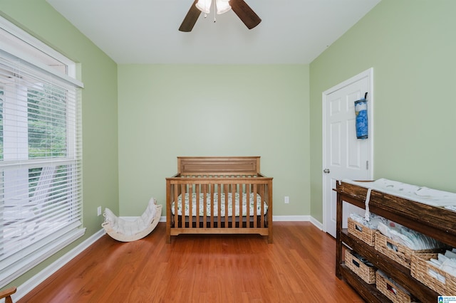bedroom featuring baseboards, ceiling fan, and wood finished floors