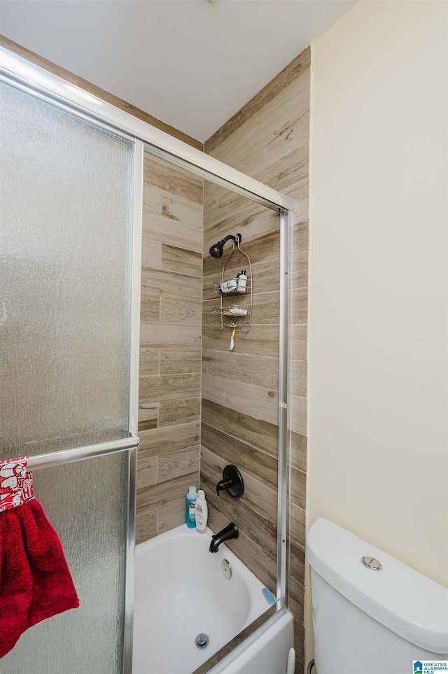 full bathroom with enclosed tub / shower combo and toilet