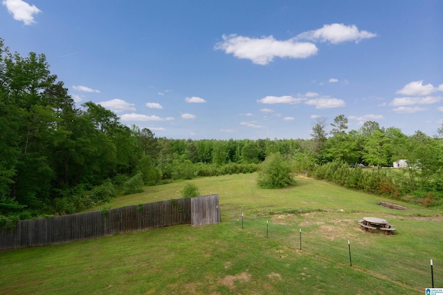 view of yard featuring fence and an outdoor fire pit