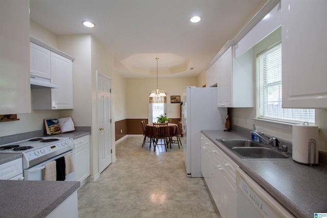 kitchen featuring a sink, white cabinetry, a healthy amount of sunlight, and white appliances