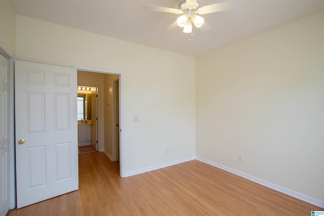 empty room with light wood-style floors, baseboards, and ceiling fan