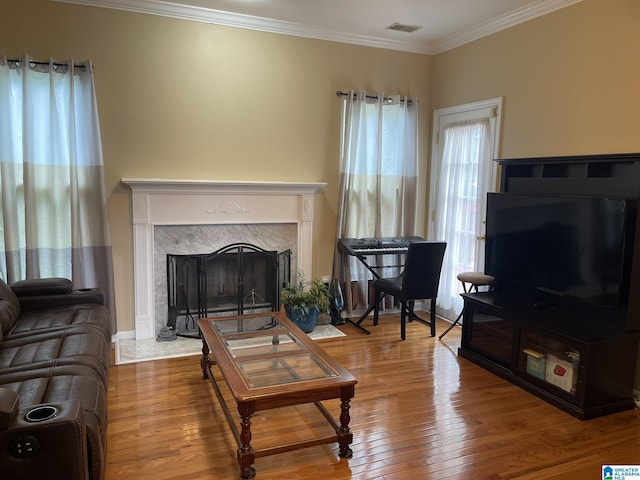 196 King James Ct, Alabaster, AL 35007 - living area featuring a fireplace, wood finished floors, and crown molding