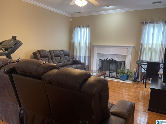 196 King James Ct, Alabaster, AL 35007 - living room featuring ceiling fan, wood finished floors, ornamental molding, and a premium fireplace