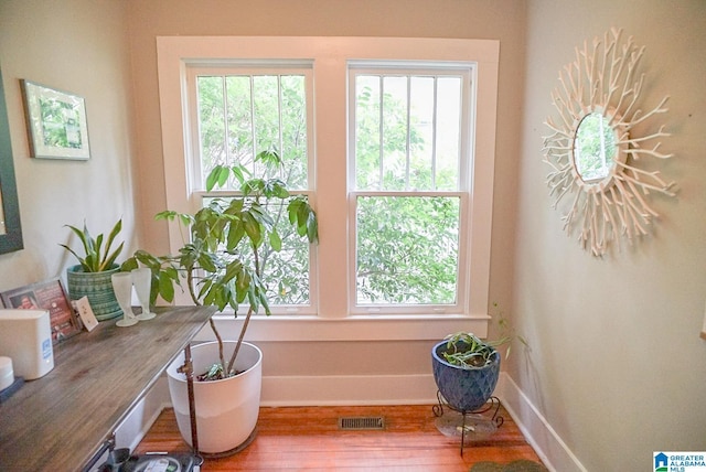 interior space featuring visible vents, baseboards, and wood finished floors