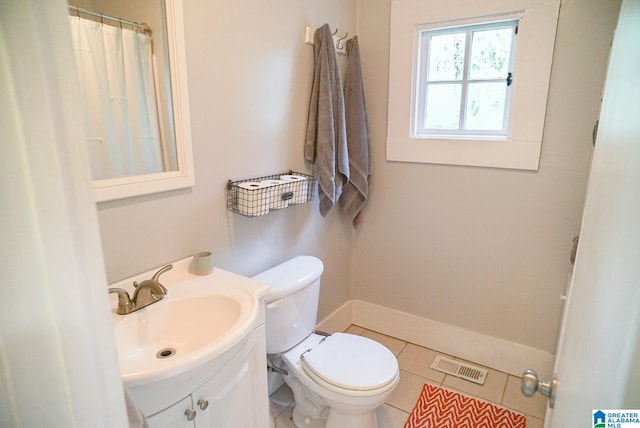 bathroom featuring tile patterned flooring, vanity, toilet, baseboards, and visible vents