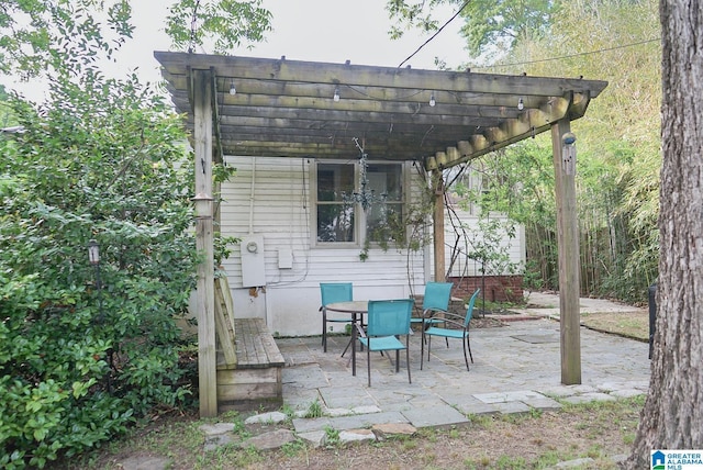 view of patio / terrace with a pergola and outdoor dining space