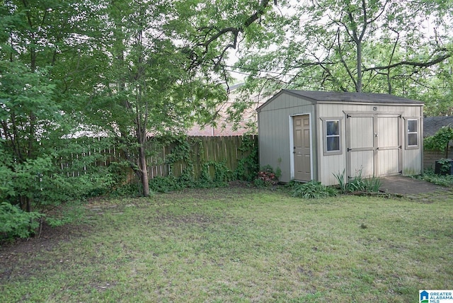 exterior space featuring fence, an outdoor structure, and a storage unit