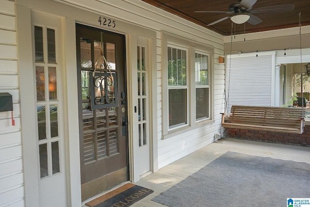 property entrance featuring covered porch and a ceiling fan