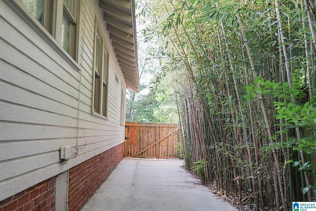 view of side of home with a gate