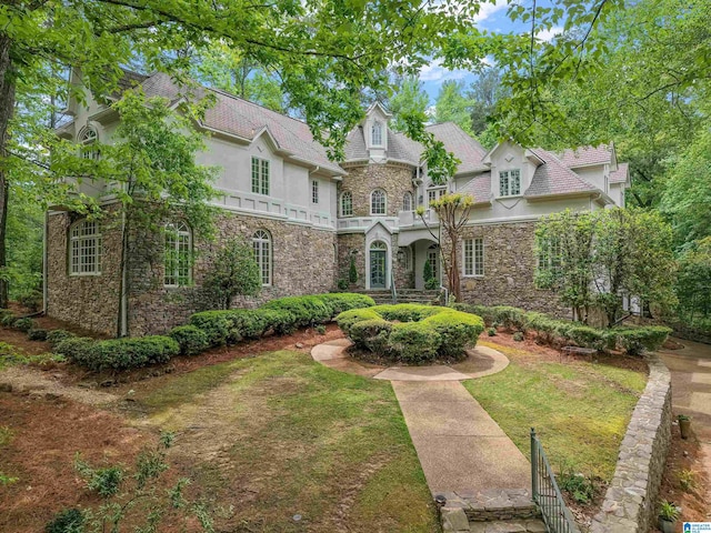 2074 Royal Fern Ln, Hoover, AL 35244 - view of front of house featuring a front lawn, stucco siding, and stone siding