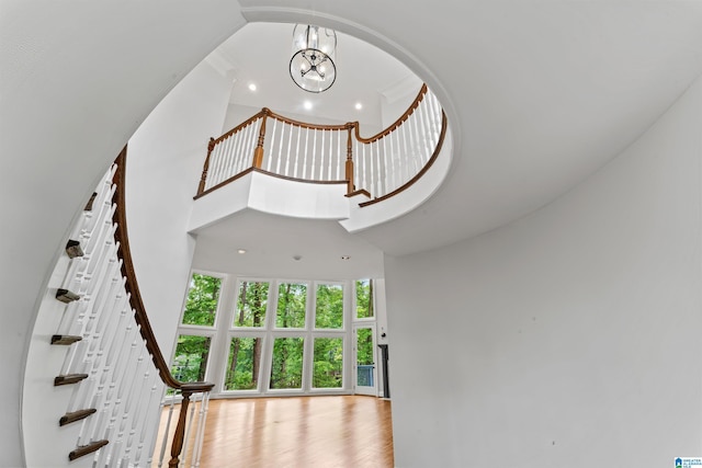 2074 Royal Fern Ln, Hoover, AL 35244 - stairway with recessed lighting, an inviting chandelier, wood finished floors, and a towering ceiling