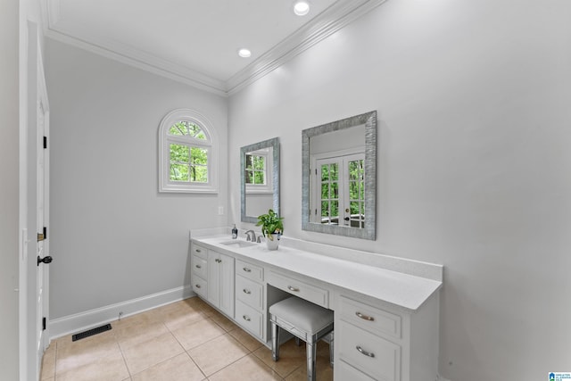 2074 Royal Fern Ln, Hoover, AL 35244 - bathroom featuring crown molding, tile patterned flooring, vanity, baseboards, and visible vents