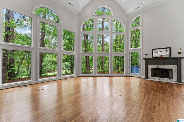 2074 Royal Fern Ln, Hoover, AL 35244 - unfurnished living room featuring a high end fireplace, high vaulted ceiling, wood finished floors, and visible vents