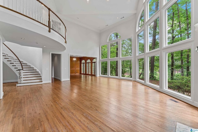2074 Royal Fern Ln, Hoover, AL 35244 - unfurnished living room featuring baseboards, ornamental molding, a towering ceiling, and stairway
