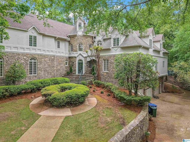 2074 Royal Fern Ln, Hoover, AL 35244 - view of front of property featuring an attached garage, stucco siding, and stone siding