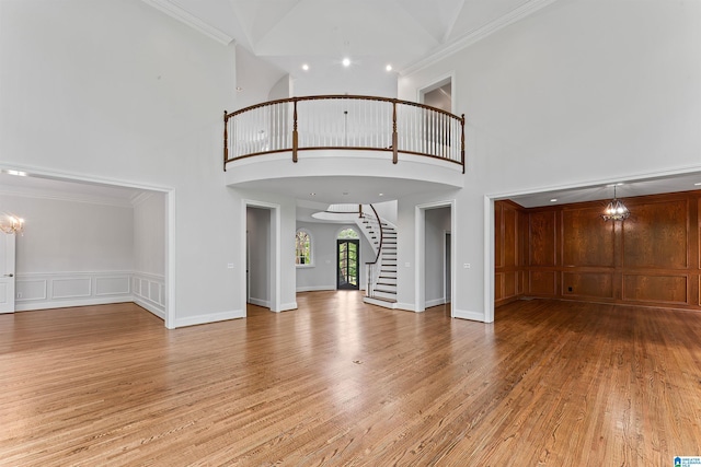 2074 Royal Fern Ln, Hoover, AL 35244 - foyer entrance featuring crown molding, a high ceiling, light wood-style floors, a chandelier, and stairs