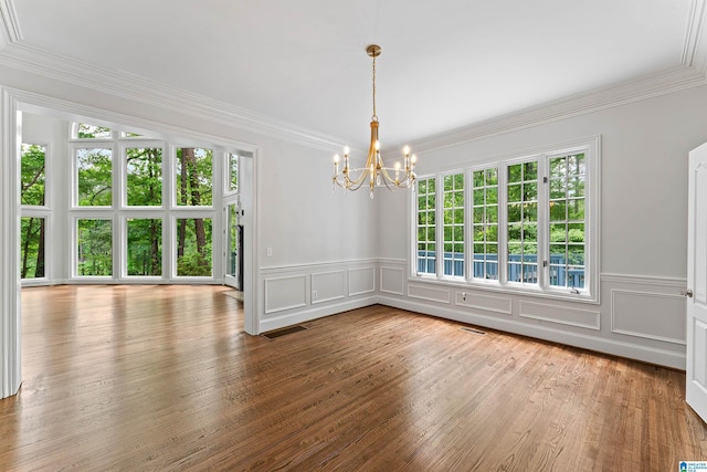 2074 Royal Fern Ln, Hoover, AL 35244 - unfurnished dining area with visible vents, crown molding, a decorative wall, a wainscoted wall, and a chandelier