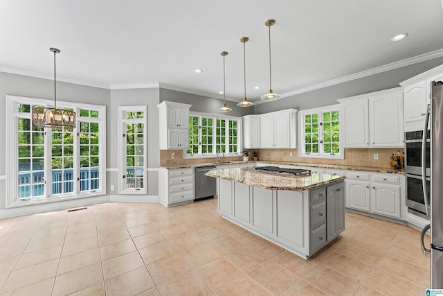 2074 Royal Fern Ln, Hoover, AL 35244 - kitchen with a center island, stainless steel appliances, white cabinetry, light tile patterned floors, and backsplash